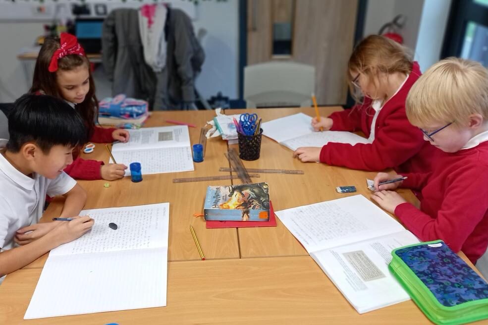 pupils working at a desk in lesson